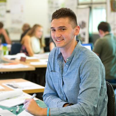 Male student smiles at camera